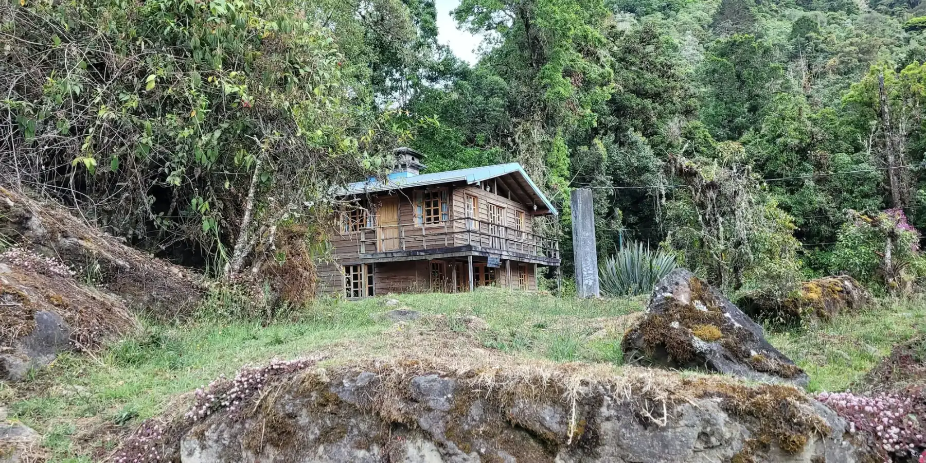 A plain wooden cabin in a cloud-forest clearing in Costa Rica.